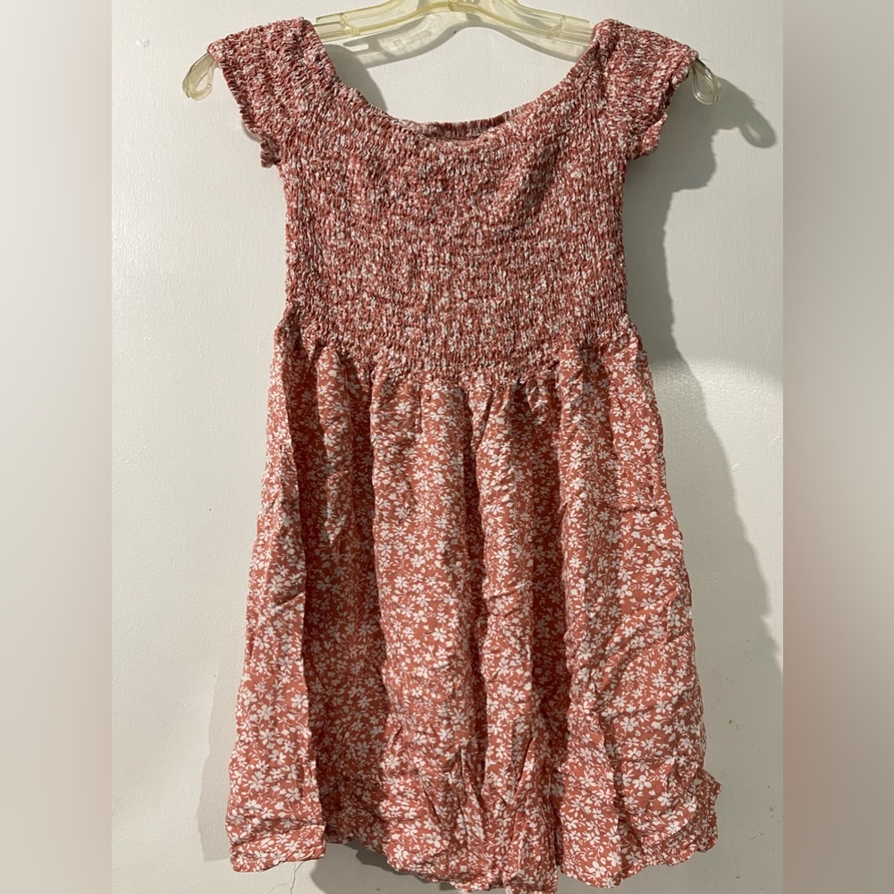 Salmon color dress.